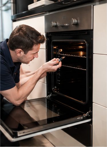 JT Service engineer repairing an oven in London